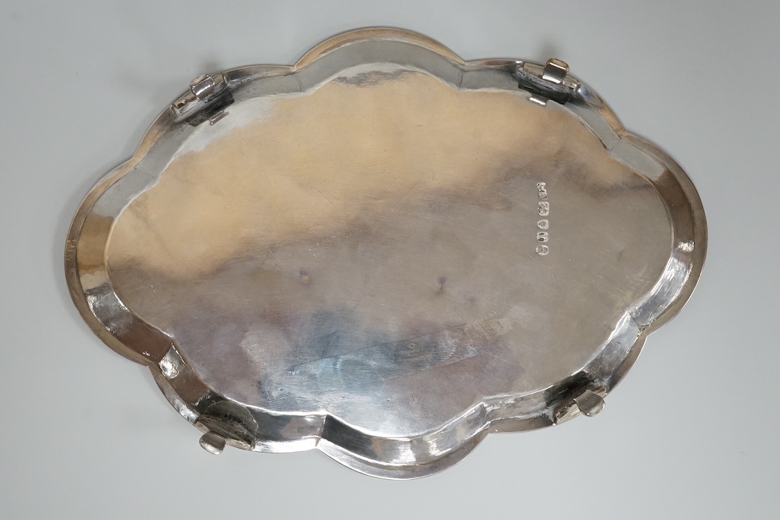 A George III silver cusped oval teapot stand, by Charles Aldridge, London, 1792, with engraved crest and foliate band, on four cabriole feet, London, 1792, 18.8cm, 5oz.